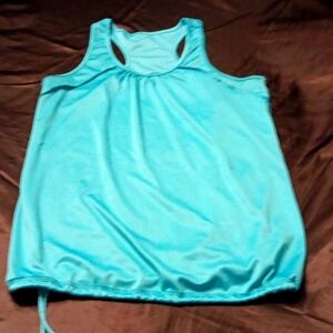 Bright blue, silky tank top with band around bottom.